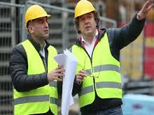 Two men in yellow vests and hard hats