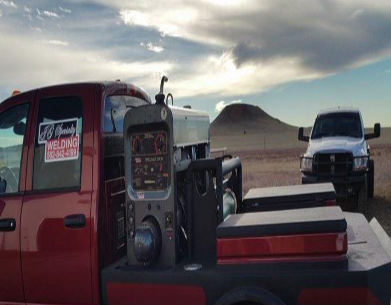 A red truck with a black and white truck in the back