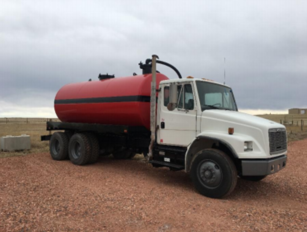 A large truck with a red tank on the back.