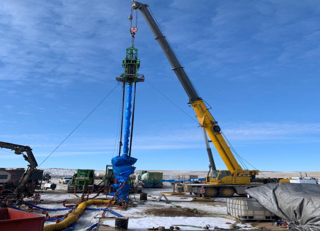 A crane is being used to lift the top of a pile.