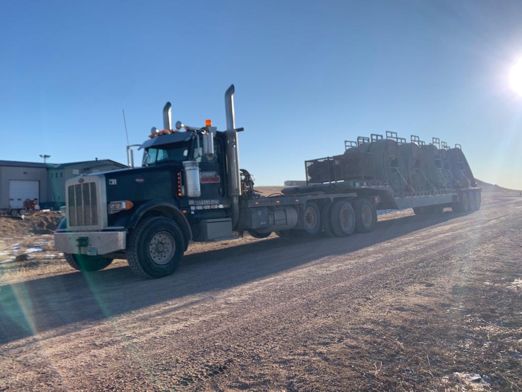 A large truck is driving down the road.