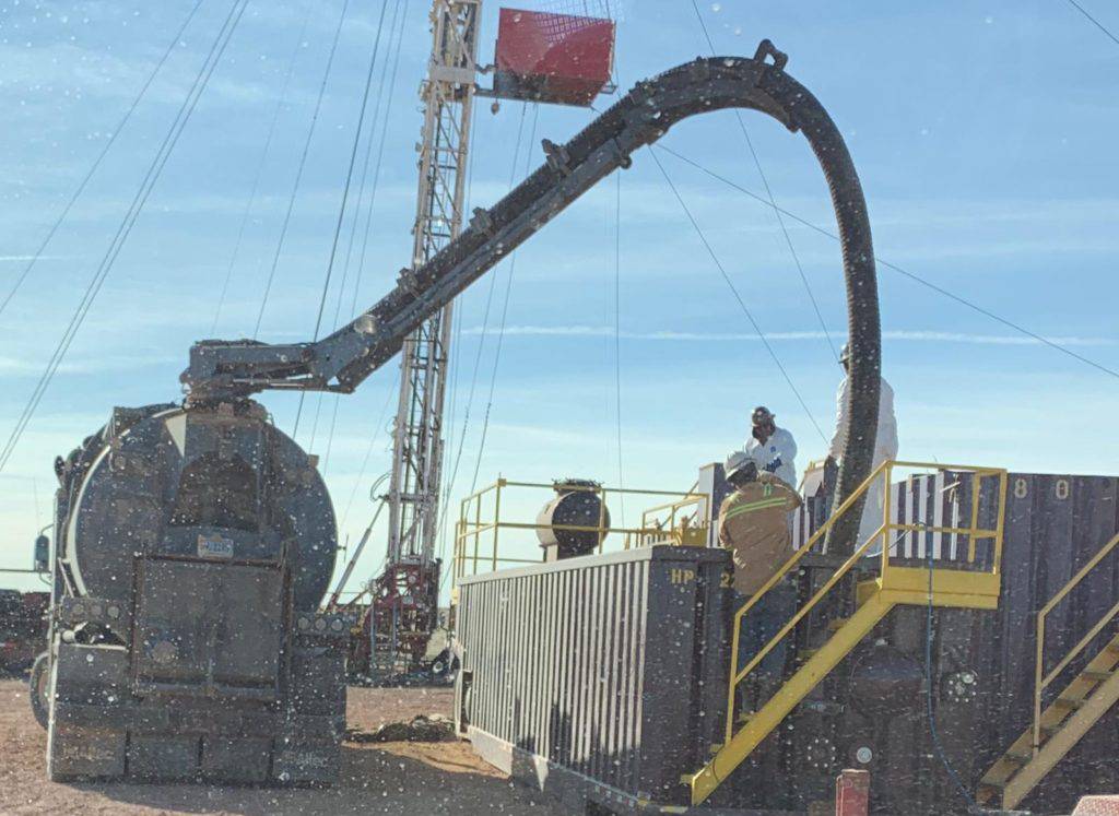 A man standing next to a large machine.