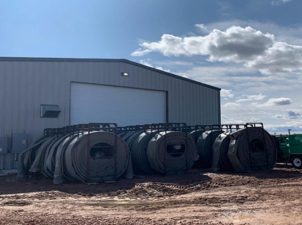 A large building with many pipes in front of it.