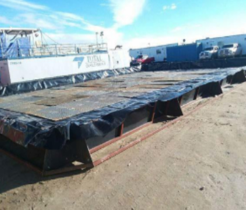 A large black container sitting on top of a beach.